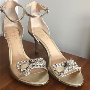 Badgley Mischka gold heels with bow embellishment